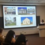 Students in a classroom watch as visiting lecturer Lindsey Walsworth presents a screen presenting restoration examples