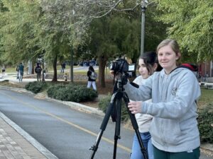 Two students with a camera and tripod on church street