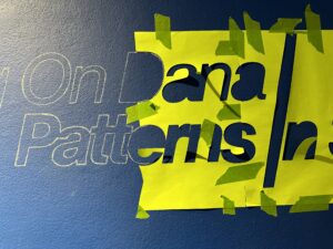 outlines of text (exhibition title) on blue wall: Building on Dana / Patterns in Space