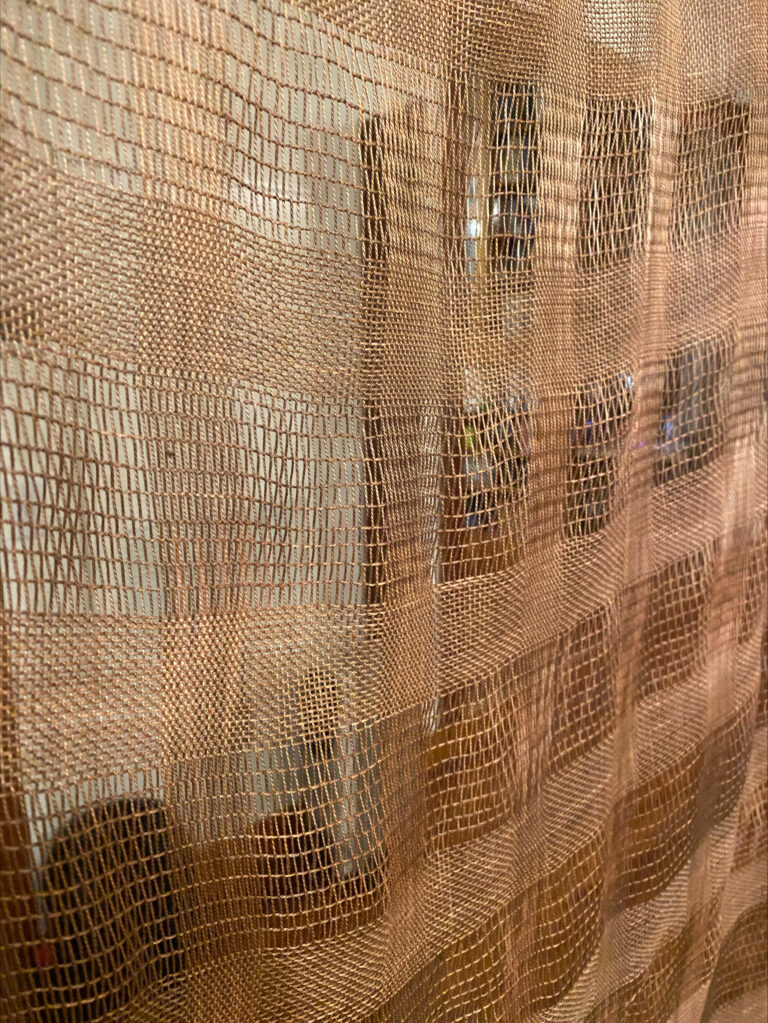 Roxie Fricton working on weaving installation inspired by patterns and light in and around Dana Fine Arts building