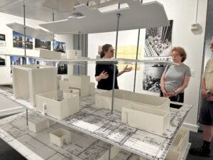 Katherine Smith stands by the model of the dana fine arts building